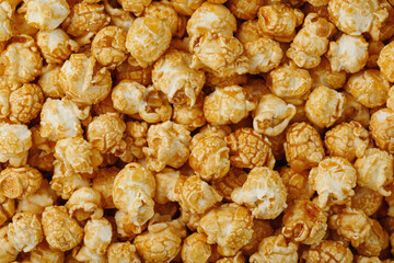 Popcorn in caramel glaze close-up as a background.