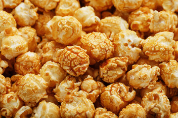 Caramel popcorn close-up as a background, full-screen texture.