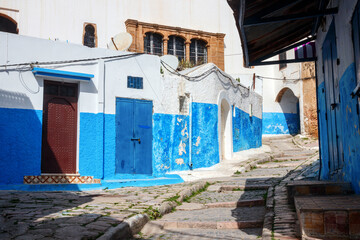 Maze of old narrow streets, stairs and alleys in the Kasbah of the Udayas with blue and white painted houses. Rabat, Morocco.