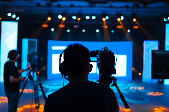 Professional cameraman - covering on event with a video, cameraman silhouette on live studio news, Selective focus