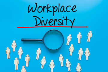 Workplace Diversity  Sign on white paper. Man Hand Holding Paper with text. Isolated on Workers concept, Magnifying glass. Blue.