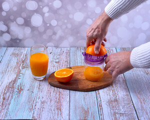 Making orange juice in a manual juicer