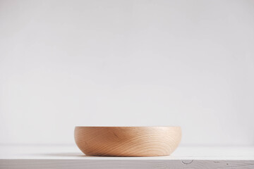 Empty wooden plate on a white table background. Copy, empty space for text