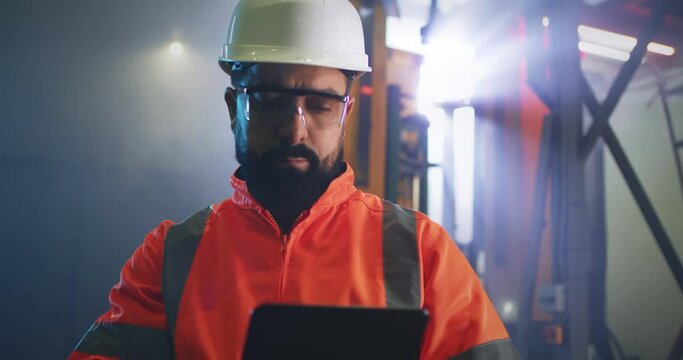 Male engineer using tablet on factory