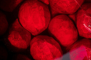 Purple-red peeled beetroots in freshwater. Beetroots background. Top views.