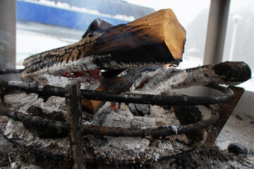 Burning a stove on a snowy day. The concept of leisure in the fresh air.