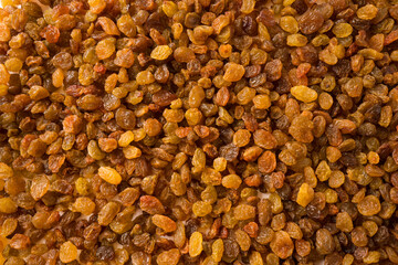 Background of raisins. Dried fruits of close up. Top view. Background raisins Kishmish. Dried fruit in the sun.