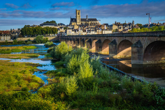 View on the gothic St Cyr Ste Juliette cathedral and the city of Nevers from the Loire River bridge