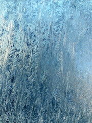 Blue and white Frost form triangles on Window in Winter