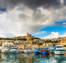 Fototapeta na wymiar Port of the island of Gozo with its fishing boats, in Malta in the far south of Europe