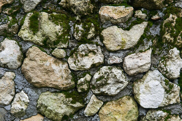 background, texture - mossy rough masonry from natural stone