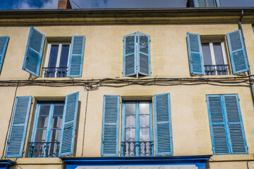 Obraz premium Cute townhouse facade with blue shutters in the historic center of Nevers, located in Burgundy, France