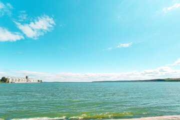Grain elevator at a reservoir with turquoise water.