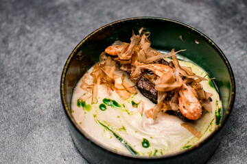 Close-up of plate with delicious meat dish with sauce and shrimps