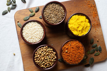 Spices and herbs in ceramic bowls. seasoning. Colorful natural additives. flat lay