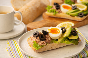 Tuna, eggs, olives  and avocado sandwiches.