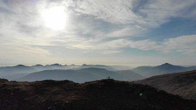 Aerial footage panning around Beinn Dubhchraig in the North of Scotland capturing some hikers bagging the munro's summit near Loch Lomond.