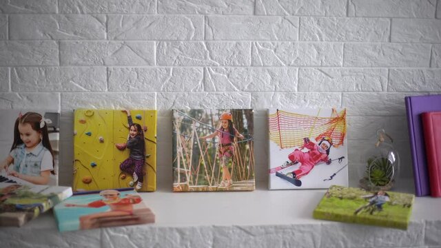 exhibition of photos, photocanvases, active little girl.