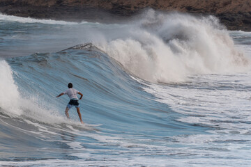 young surfer rides a wave in Gran Canaria. Canary Islands