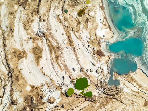 Aerial view of colorful sinkholesat the shores of the dead sea, Jordan Rift Valley, Israel.