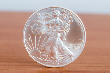 1oz fine silver one dollar (Bullion Coin). Side with Walking Liberty and United States' official motto: in god we trust.