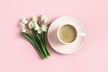 Obraz na płótnie Canvas Spring flowers and cup of coffee on pastel pink background. Mothers Day, Birthday, morning coffee, springtime concept. Top view. 