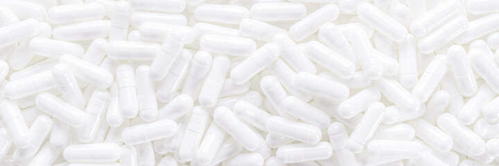 Long panoramic background with whites medical capsules