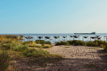 Photos of a barge floating on the lake and boats hanging near the shore