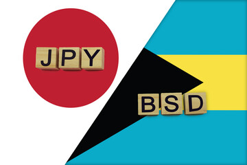 Japan and Bahamas currencies codes on national flags background