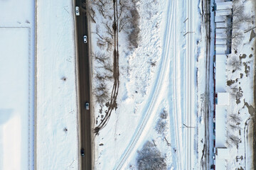 snow-covered road and railway tracks