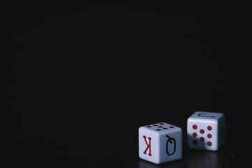 black background with two poker dice on one side