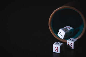 poker cup with dice on a black background,poker game