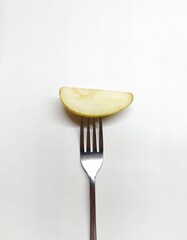 a slice of pear on a fork