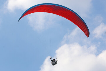 Paraglider flying wing in a blue sky	