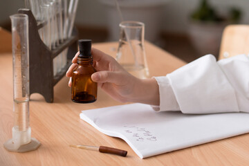 test tubes, pipette, iodine bottle, chemistry records, formula, woman's hand, laboratory tests and...