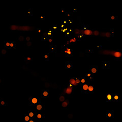Particles of burning embers fly and glow isolated in the night sky. Bright yellow sparks on a black background, yellow bright round bokeh.