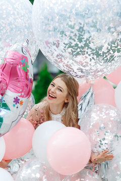 Portrait Of A Woman In A Pile Of Giant Balloons.