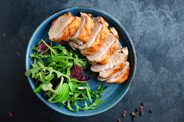 roasted duck breast and salad leaves grill or barbecue meat poultry portion on the table for healthy meal snack outdoor top view copy space for text food background rustic image