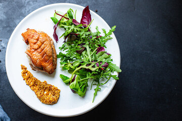 roasted duck breast and salad leaves grill or barbecue meat poultry portion on the table for healthy meal snack outdoor top view copy space for text food background rustic image