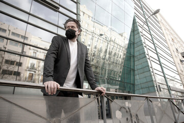 businessman outdoors in front of modern buildin                    