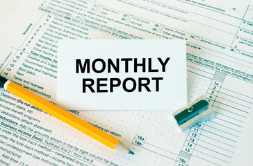 Obraz premium Business card with text Monthly Report on financial docs