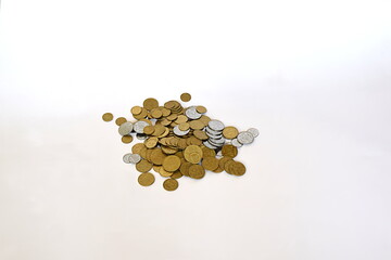 Coins of Ukrainian money in bulk on a white background.