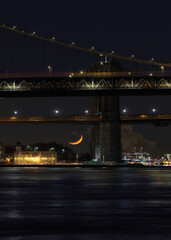 Fototapeta na wymiar View on East river and Two bridge with waxing crescent moonset 