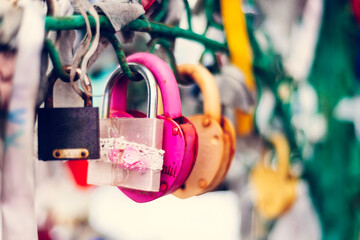 Many bright, colored  iron  love romantic padlocks, wedding padlocks, love locks. Symbol of eternal love hanging on the railing. Together forever