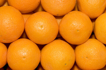 Rows of oranges at the market as background
