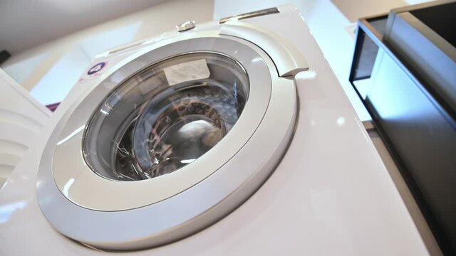 rows of washing machines in domestic appliances store
