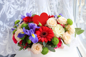 Happy Valentine's Day greeting card. beautiful bouquet of flowers and red heart 
