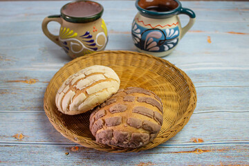 shells. traditional mexican bread with colorful mexican cups for coffee, on vintage boards