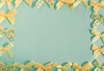lots of yellow bows.small bows.yellow bows on a blue background.the frame is made of bows.close-up of bows
