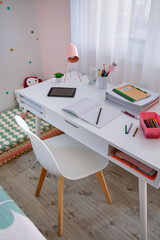 White desk in girl's bedroom decorated in pastel colors